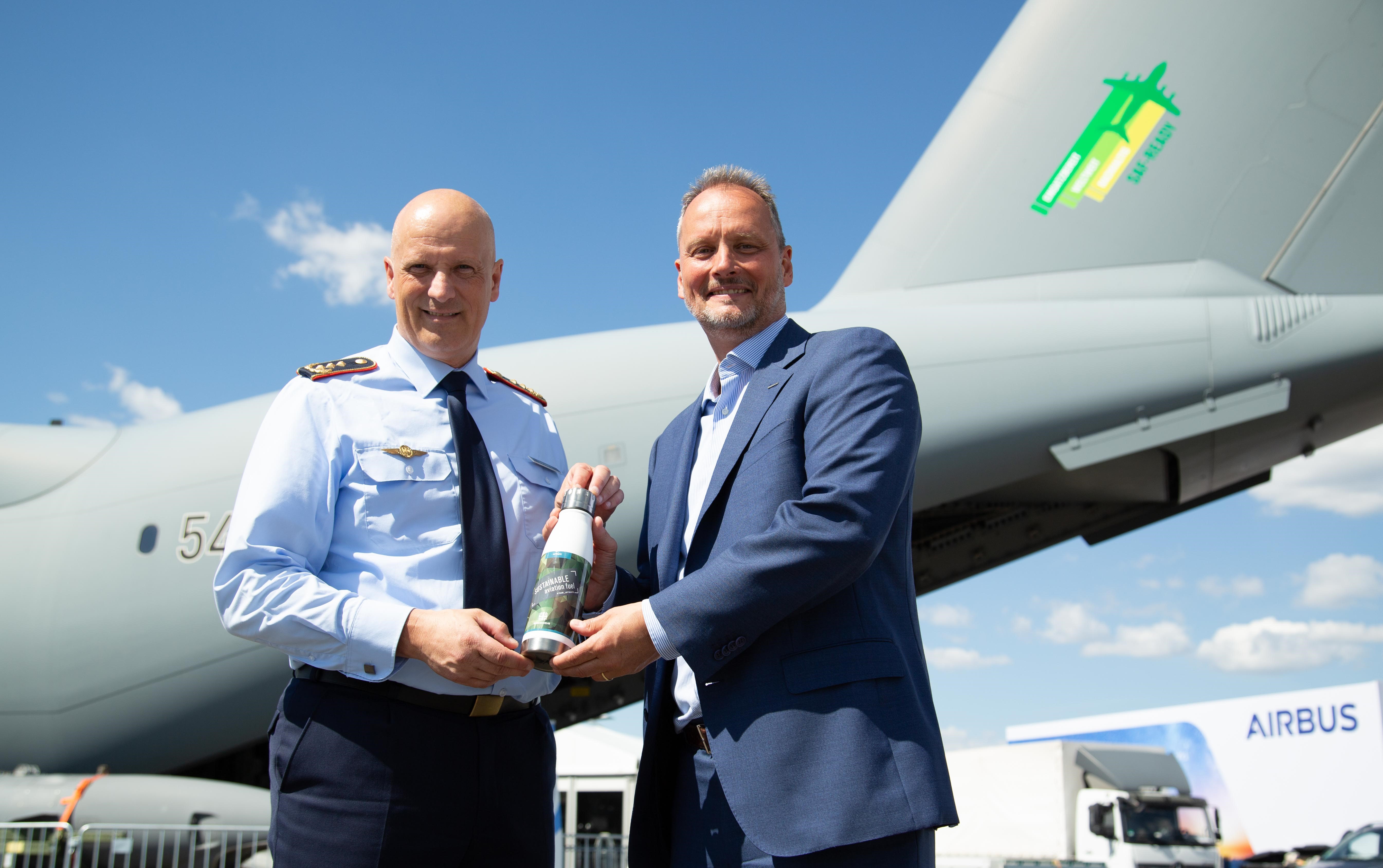 Mike Schoellhorn, Chief Executive Officer of Airbus Defence and Space, handing over a bottle of water to Lt.Gen. Ingo Gerhartz, Chief of the German Air Force, as a symbolic gesture of the Airbus agreement supporting the German Air Force in their long-term transformation to increase sustainability of its aircraft fleet. 